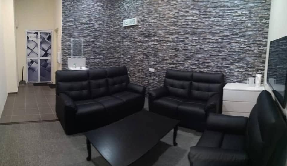 The waiting area at Klinik Lai, with seating and a feature wall.